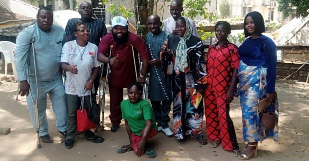 Members of the NPSGGG PWDs Chapter seated together under canopies at a chapter gathering, including members using wheelchairs and crutches.